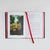 An open book with printed text on both pages and a red satin ribbon bookmark, photographed from above on a light gray background.