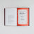 An open hardcover book laid flat on a light gray background, showing printed interior pages on the left and a red signature page on the right with visible signatures including one from author Jason Rekulak.