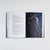 Open book spread featuring a full-page character artwork illustration opposite a text page