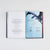 Open book spread featuring a custom tipped-in page with author Rebecca Yarros's signature and decorative art borders